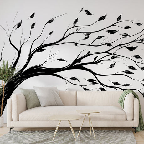 Black and white tree wallpaper creating depth in a modern minimalist living room with natural light streaming through windows