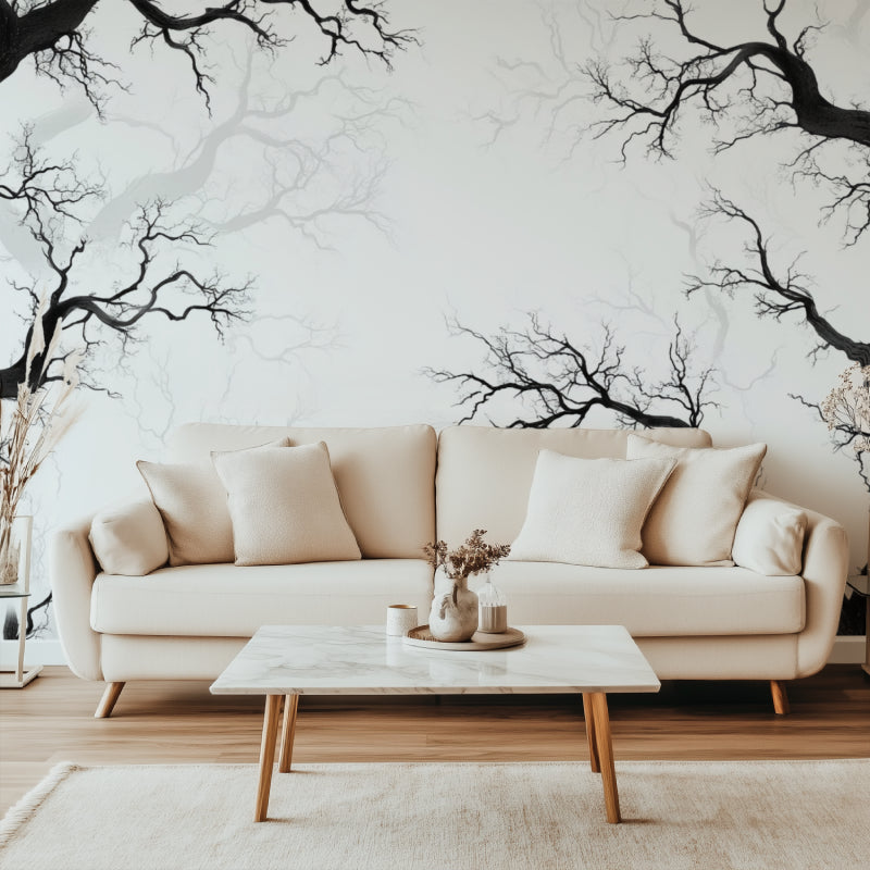 Black tree branch wallpaper creating depth in modern living room with grey sofa and natural light
