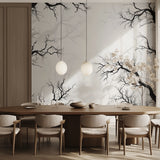 Black and white tree mural in dining room with wooden table and pendant lights
