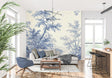 Blue Toile de Jouy wallpaper in an elegant dining room with crystal chandelier and white wainscoting