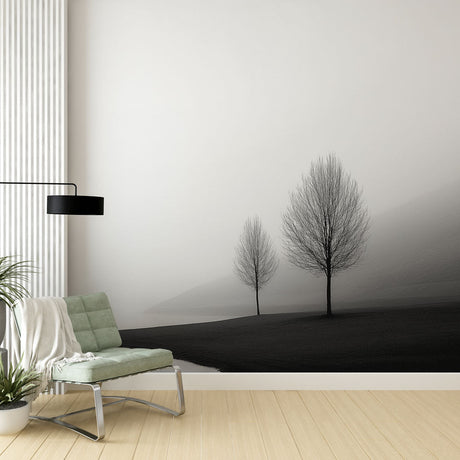 Black and white tree wallpaper mural creating a peaceful atmosphere in a modern minimalist living room setting