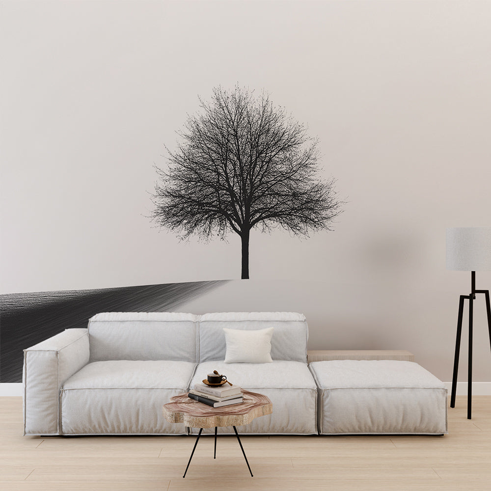 Minimalist black and white tree wallpaper creating a striking focal point in a modern living room with clean furniture lines