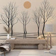 Minimalist tree wallpaper creating depth in a modern living room, black silhouettes against warm beige tones