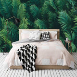 Green fern wall mural adding depth to a cozy bedroom setting