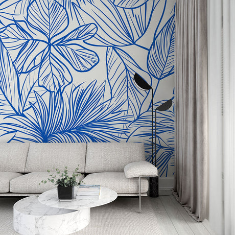 Blue tropical line art wallpaper in a bright modern living room, showing the pattern's clean aesthetic and room-expanding effect