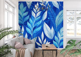Coastal bedroom featuring blue palm leaf mural wallpaper with rattan furniture