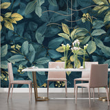 Teal and gold botanical wallpaper creating depth in dining room setting