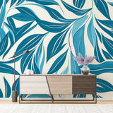 Modern blue leaf wallpaper displayed in a bright living room, creating a fresh tropical atmosphere with natural light
