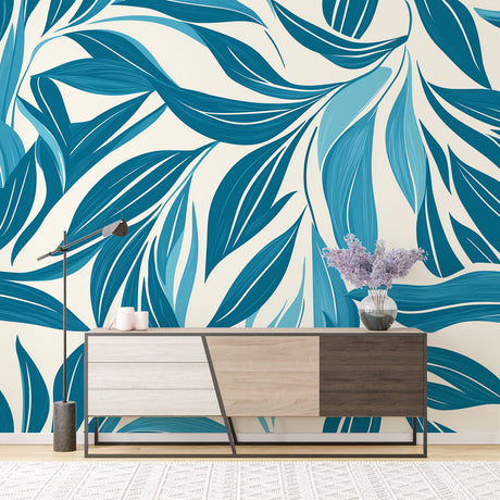 Modern blue leaf wallpaper displayed in a bright living room, creating a fresh tropical atmosphere with natural light