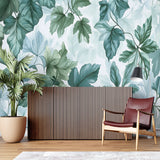 Botanical wall mural transforming a minimalist entryway with sage green leaves