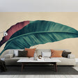 Tropical leaf wallpaper in modern living room showing large-scale burgundy and green botanical design against beige wall