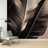 Tropical leaf wallpaper in minimalist black and beige creating a calm atmosphere in a modern living room setting