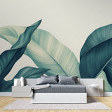 Dining room with botanical wall mural showing large-scale tropical leaves in teal