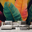 Tropical leaf wallpaper creating depth in modern living room, emerald banana leaves with gold details against black background