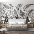 Black and white botanical line art wallpaper creating a stunning backdrop in a modern living room with minimal furniture