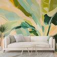 Tropical leaf wallpaper creating a stunning accent wall in a modern living room with natural light and minimal furniture