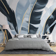 Tropical leaf wallpaper with gold accents creating a luxury feel in a modern living room with natural light