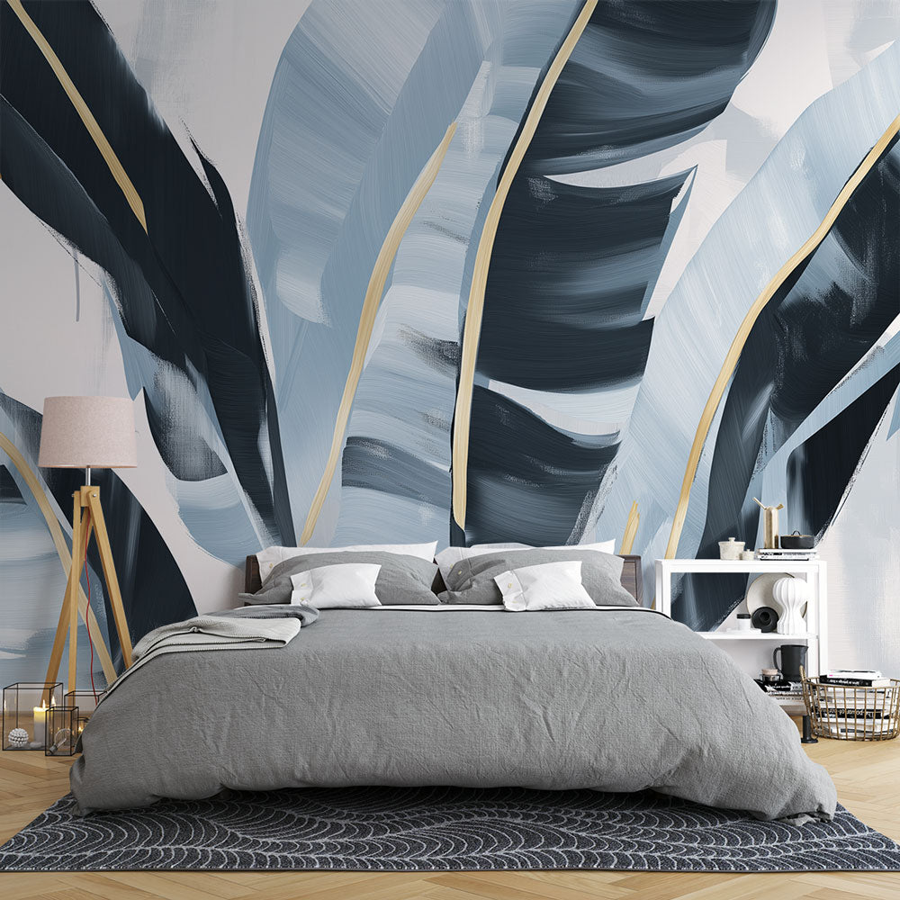 Tropical leaf wallpaper with gold accents creating a luxury feel in a modern living room with natural light