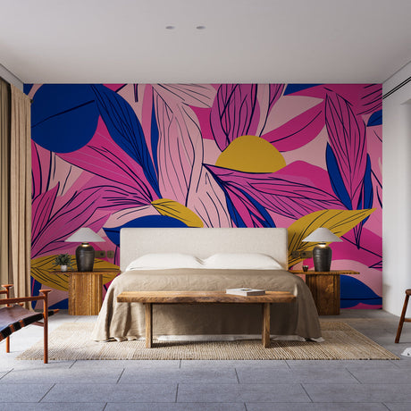 Pink and blue tropical leaf wallpaper creating a modern accent wall in a bright living room with minimal furniture
