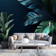 Tropical banana leaf wallpaper in modern dining room with dark navy backdrop and emerald green leaves creating dramatic atmosphere