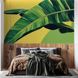 Tropical banana leaf wallpaper creating a stunning accent wall in a modern dining room with natural light