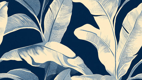 Tropical leaf wallpaper with white banana leaves on navy creating depth in a modern dining room setting