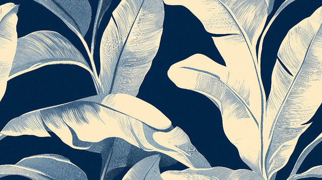 Tropical leaf wallpaper with white banana leaves on navy creating depth in a modern dining room setting