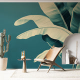 Tropical banana leaf wallpaper creating a peaceful atmosphere in a modern living room with natural light