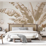 Beige Tropical Leaf Wallpaper bringing calm elegance to a modern living room with natural light and minimal furniture