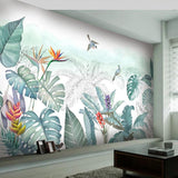 Tropical birds and monstera wallpaper creating a peaceful atmosphere in a modern living room setting