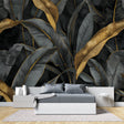 Tropical black and gold banana leaf wallpaper in modern dining room with golden accents