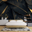 Black and gold tropical banana leaf wallpaper in modern dining room with pendant lights highlighting metallic accents