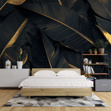 Black and gold tropical banana leaf wallpaper in modern dining room with pendant lights highlighting metallic accents