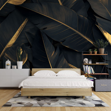 Black and gold tropical banana leaf wallpaper in modern dining room with pendant lights highlighting metallic accents