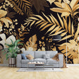 Black and gold tropical wallpaper creating dramatic impact in a modern living room with tall windows