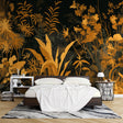Tropical black and gold wallpaper in modern living room, golden palm leaves on dark background creating dramatic atmosphere
