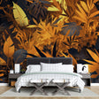 Black and gold tropical wallpaper creating depth in a modern living room with pendant lights and minimal furniture
