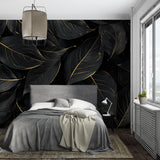 Black and gold leaf wallpaper in modern dining room with pendant lights highlighting metallic details