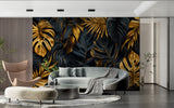 Black and gold Monstera leaf wallpaper in modern living room setting with grey sofa