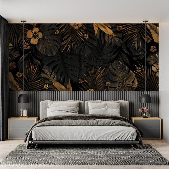 Black and gold Monstera leaf wallpaper creating drama in a modern living room with minimal furniture