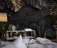 Black and gold Monstera leaf wallpaper in modern living room with grey sofa and pendant lights