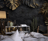 Black and gold Monstera leaf wallpaper in modern living room with grey sofa and pendant lights