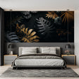 Black and gold Monstera leaf wallpaper in modern dining room with mood lighting highlighting metallic accents
