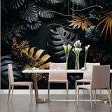 Botanical black and gold mural creating cozy atmosphere in reading nook with accent chair
