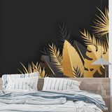 Black and gold tropical palm leaf wallpaper in modern living room with tall windows