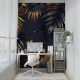 Home office space with black and gold tropical leaf wallpaper creating professional ambiance