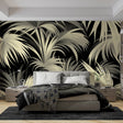 Black and gold tropical palm wallpaper creating drama in a modern dining room with ambient lighting