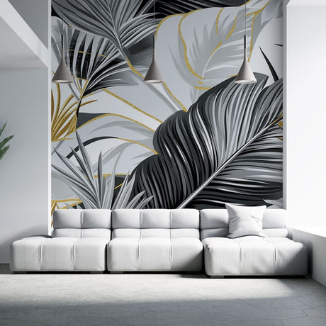 Tropical palm leaves wallpaper in black and gold creating drama in a modern living room with high ceilings
