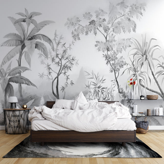 Black and white tropical wallpaper creating depth in modern living room with grey sofa