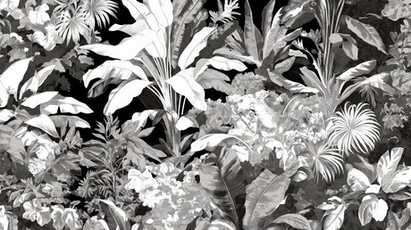 Black and white tropical botanical wallpaper creating drama in a modern living room with high ceilings and minimal furniture